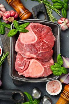 Raw meat. Fresh ossobuko beef steak. Meat on a plastic black container from the market. Close-up.