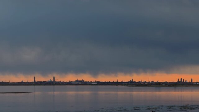 Distant Coastal City Skyline Under Gray Cloudy Sky