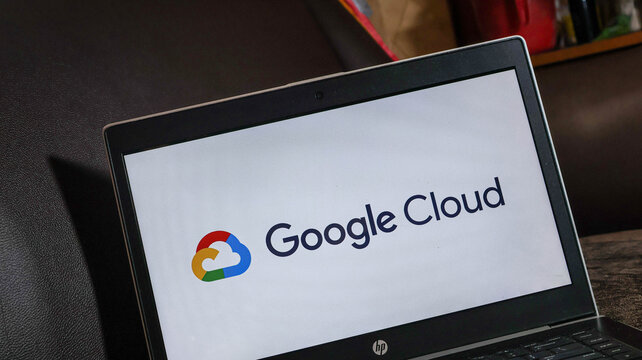 Google cloud logo on a laptop screen in a modern office setting with a blurred background