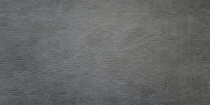 A close-up, textured surface of dark gray leather showcases its natural grain and subtle sheen, offering a versatile background for design or material studies.