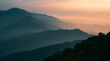 Obraz premium Misty mountains bathed in golden hour light create a breathtaking and serene landscape view