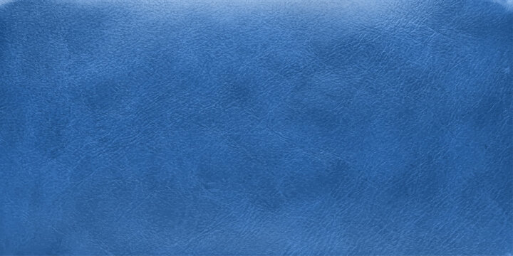 A macro shot of textured denim fabric in a deep blue hue, showcasing subtle variations in color and weave.