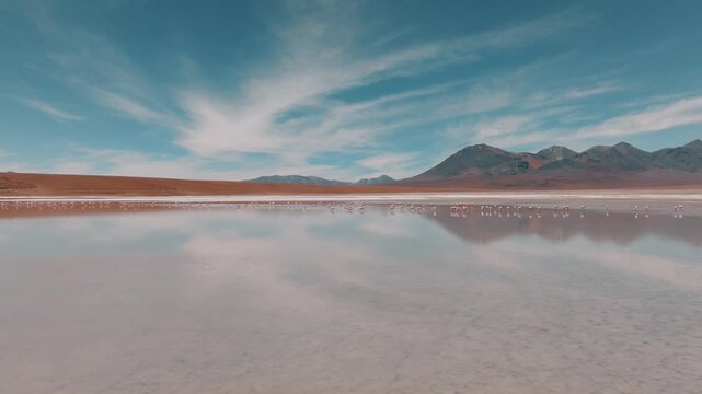 Aerial view of a turquoise Andean lagoon surrounded by volcanic peaks in the remote landscapes of Bolivia&rsquo;s Sud L&iacute;pez region.