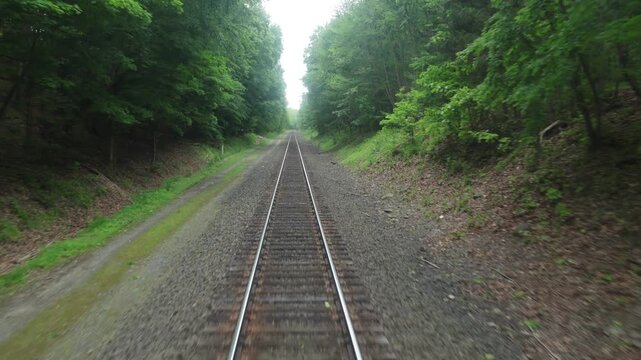 view of moving train tracks from the back of metro car window new york jersey transit north (riding subway travel transportation) gravel rail track bed