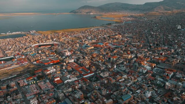 Drone view of Puno, a high-altitude city on the shores of Lake Titicaca in Peru. Urban districts and Andean landscapes surround the world&rsquo;s highest navigable lake.