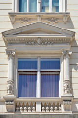 Obraz premium Close up of an elegant 19th century architectural window frame with classical columns and relief details on a historic building facade in Zagreb Croatia.