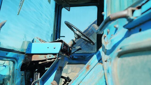 Detailed view inside aging MTZ Belarus tractor showing worn controls and cabin
