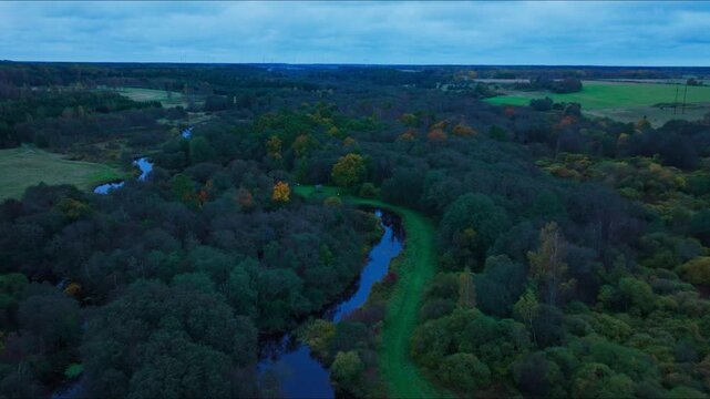Drone Flight Above Meandering Sventaja River Through Borderland Forests