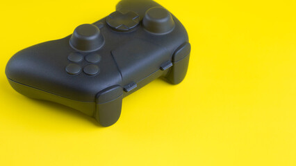 Close up of blank black gamepad mockup on yellow background with negative space for gaming design.  © wibiwisnu