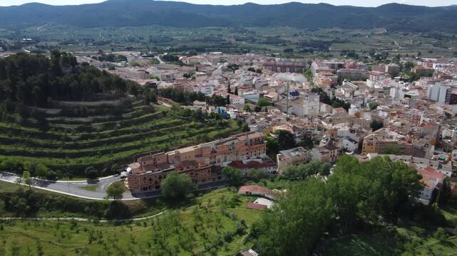Aerial reveal of the town of Ibi, Spain. Surrounded by mountain ranges.