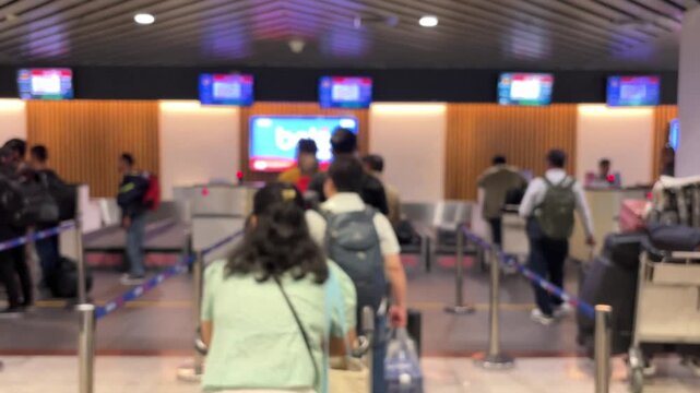 Passengers queue to board a plane at the airport terminal. Blur video.	