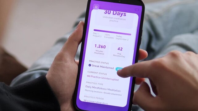 POV of a user reviewing their 30 day meditation streak on a mobile app. The interface displays 1,260 minutes meditated and a perfect consistency score. Ideal for illustrating personal growth