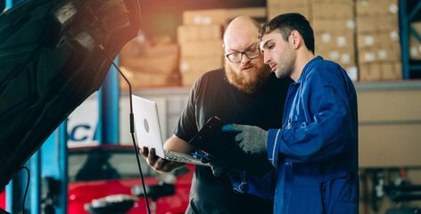 Fototapeta premium Auto mechanic car repair laptop clipboard workshop technician vehicle maintenance garage professional teamwork inspection mechanic uniform automotive engine hood discussion industrial