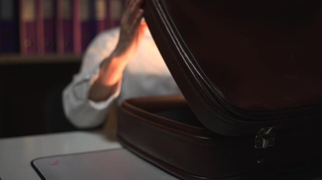 Black suitcase on table in warm indoor setting