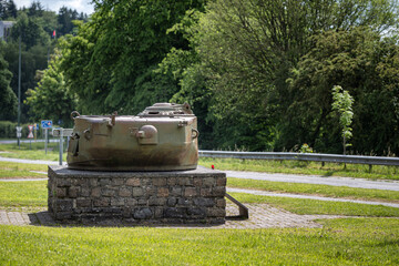 Historical WWII Sherman tank turret monument on a stone pedestal by the road in Bastogne, Belgium. Battle of the Bulge memorial. © Rudolf