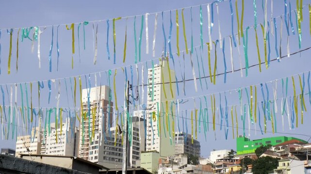 Green and yellow flags in a Brazilian neighborhood celebrating the 2026 World Cup.