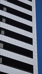 Fototapeta premium Modern building facade creating abstract striped pattern