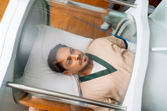 Young man receiving hyperbaric oxygen therapy treatment