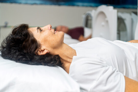 Smiling senior woman undergoing hyperbaric oxygen therapy