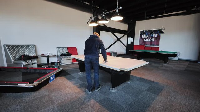 Craftsman positions slate sections precisely to restore optimal playing surface