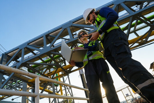 Engineering project team conducting a critical site audit and schematic review of pipeline infrastructure to verify system specifications and operational compliance.