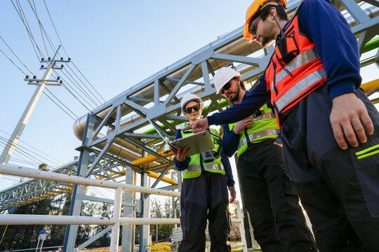 Engineering view of large-scale industrial process pipelines with metallic thermal insulation, highlighting complex pipe rack integration and structural steel supports at an energy facility.