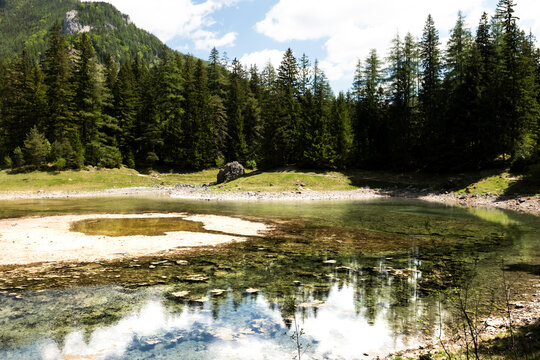 Seasonal emerald alpine lake Gruner See in Styria, Austria, highlighting fragile alpine habitats under environmental stress