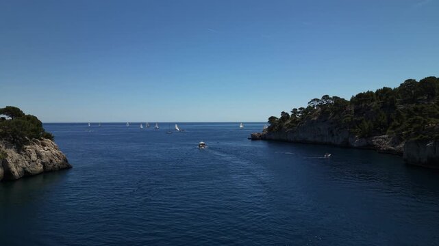 Aerial 4K view of a drone flying forward through the narrow bay canyon of Cassis calanques towards the open Mediterranean sea, France