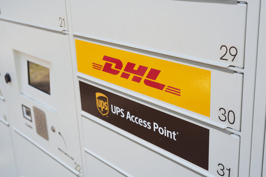 Dusseldorf, Germany - May 28 2026: DHL and UPS Access Point parcel locker compartments for package collection