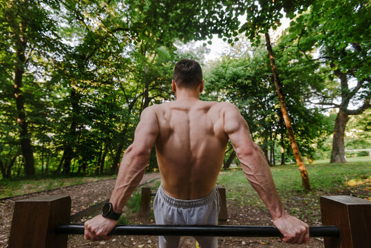 Muscular Athlete Performing Dip Exercise Outdoors