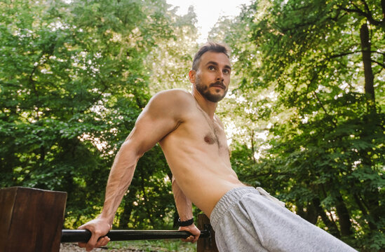 Athlete Performing Parallel Bar Exercise Outdoors