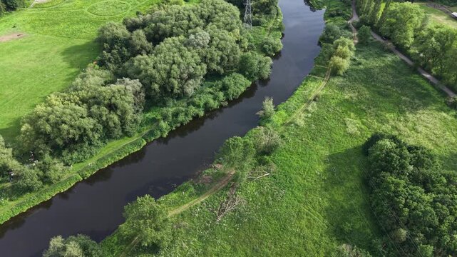 Aerial drone 4K footage showing central buildings positioned beside woodland greenery with warm natural tones Burton on Trent