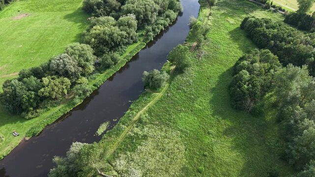 Aerial drone 4K footage showing central buildings positioned beside woodland greenery with warm natural tones Burton on Trent