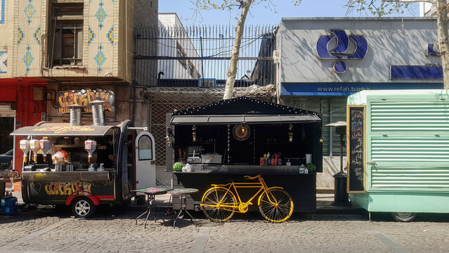 Tehran, Iran - November 18, 2018 - Sunny Day Street Food Stalls with Yellow Classic Bicycle on Si Tir Street Tehran
