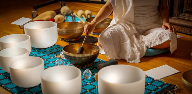 Stress Relief Sound Bath Meditation with Woman Playing White Quartz Crystal Singing Bowls in sound therapy