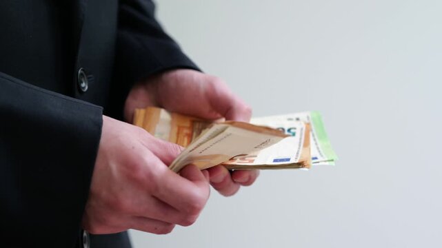 Man holds stack of euro banknotes as concept of financial stability and income.