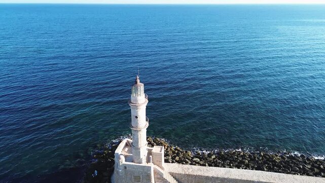 bay of Chania with sea and lighthouse at sunny summer sunset, Crete, Greece,