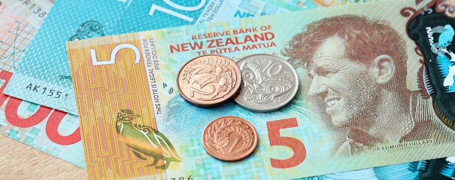 New Zealand dollar money bills and coins on table. New Zealand cash of NZD currency