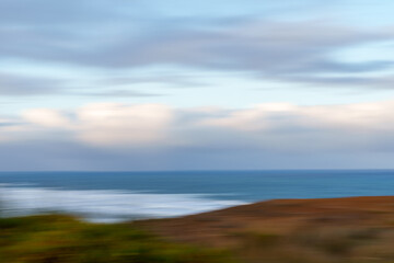 Obraz premium View from the coastal cliffs overlooking the Tasman Sea. It highlights west coasts famous rugged coastline, native New Zealand tussock and similar grasses in foreground