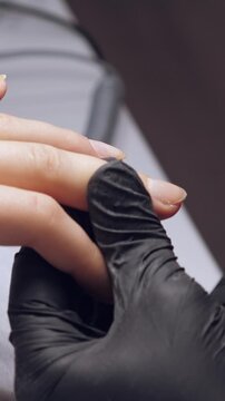 Manicure process. Correction of female nails with nippers. Vertical footage
