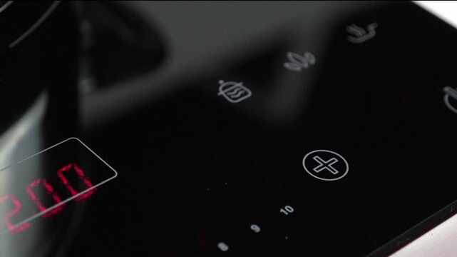 Adjust function on Induction stove and set power of heating, closeup
