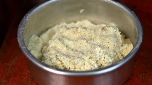 Raw Chhena Poda Cake Batter Pressed In Baking Pan Close Up. Close Up Of Fresh Cottage Cheese Cake Mixture Ready For Baking. Indian Food Close Up View.