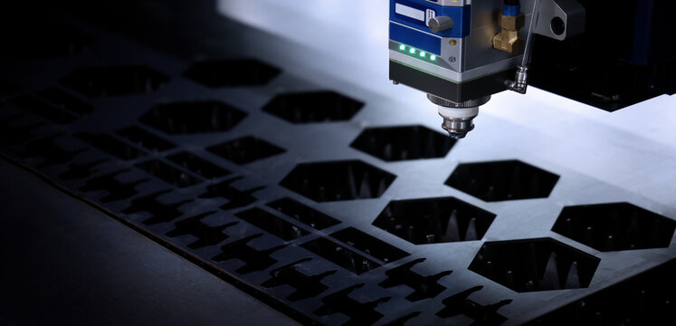 Laser cutting machine. High precision laser cutting robot processing sheet metal in factory. Ai automated CNC manufacturing technology creates intricate components with sparks accuracy and efficiency