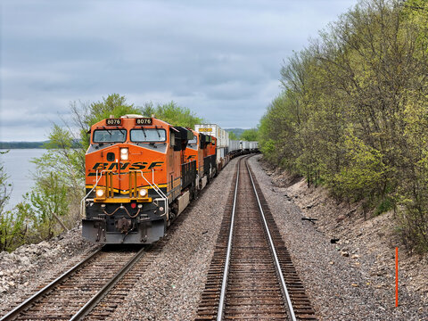Savanna, Illinois - USA - April 24, 2026; BNSF railroad locomotive pulling a freight train of cars along the backwaters of the Mississippi river