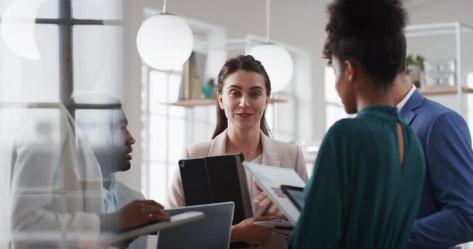 Business woman, discussion and group with tablet, happy and proposal planning in glass office. Corporate people, meeting and team leader with pitch preparation, technology and strategy in workplace