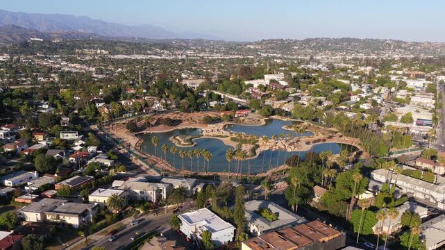 Urban oasis in Los Angeles, showing Rowena Reservoir in Los Feliz, green spaces, residential neighborhoods, and the San Gabriel Mountains