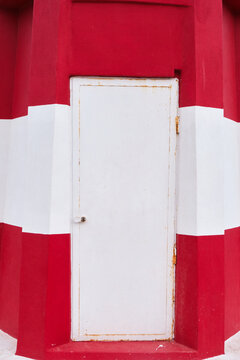 d&eacute;tail de la fa&ccedil;ade d'un phare en b&eacute;ton rouge et blanc