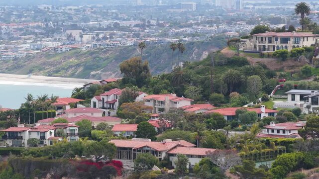 Scenic flight over the Palos Verdes Peninsula coastline in Los Angeles county, coastal bluffs, secluded cove, Pacific Ocean under cloudy sky