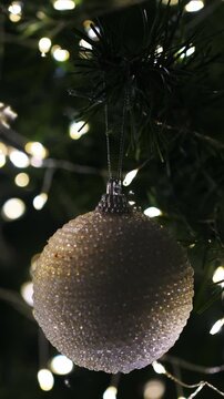 Christmas spruce tree decorated with balls and toys. New Year celebration. Closeup. Vertical footage
