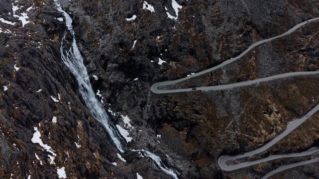 Drone Flight Above Trollstigen Hairpin Turns and Mountain Waterfall